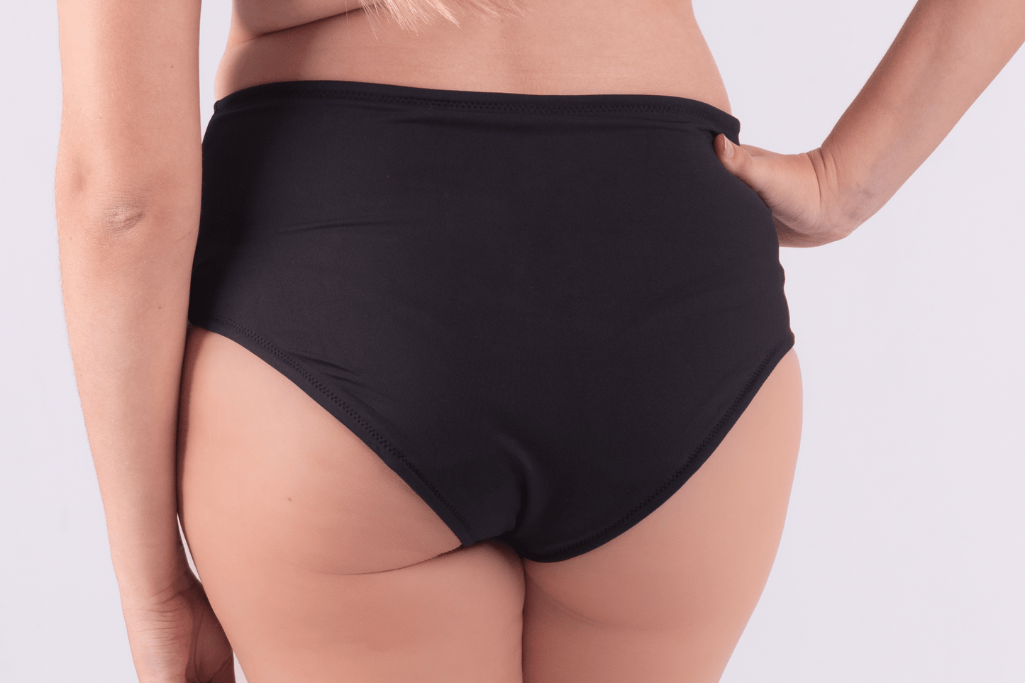 Teen wearing period swim crop top and bikini bottom set