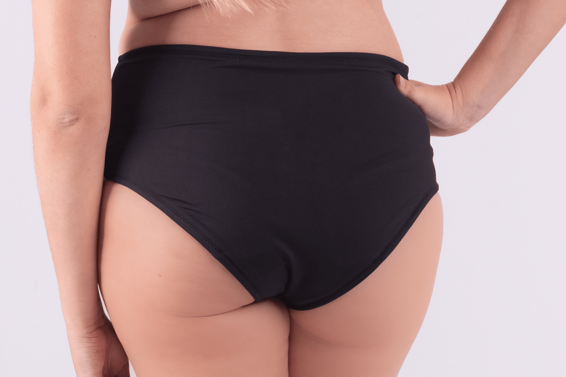 Teen wearing period swim crop top and bikini bottom set