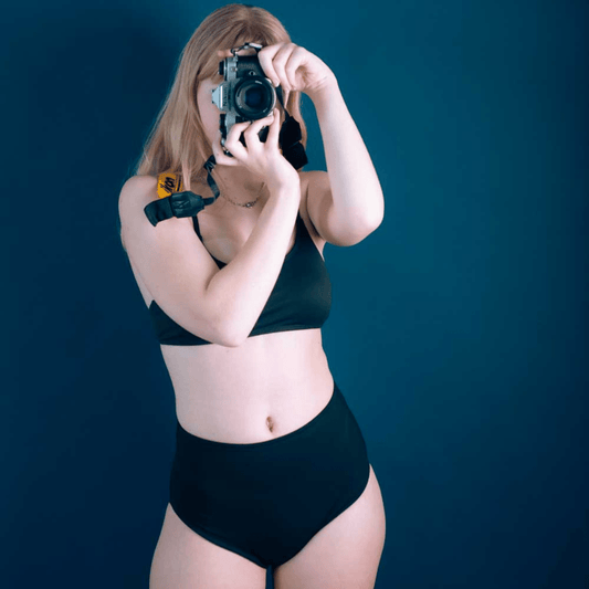 Teen wearing period swim crop top and bikini bottom set