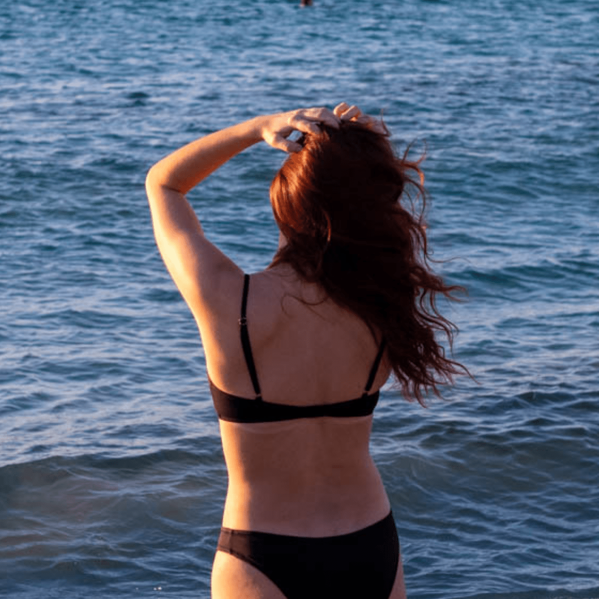 Teen girl wearing matching period-proof swimwear set beach day