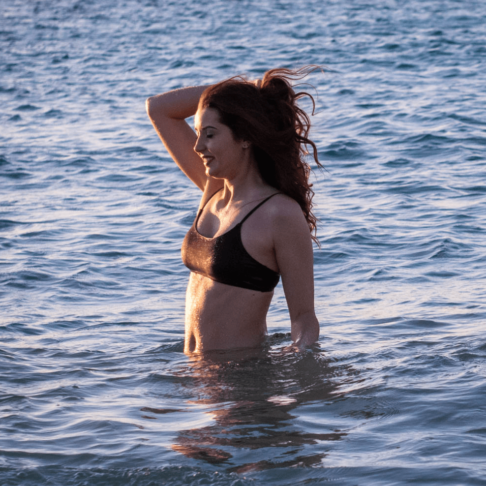 Teen girl wearing matching period-proof swimwear set beach day